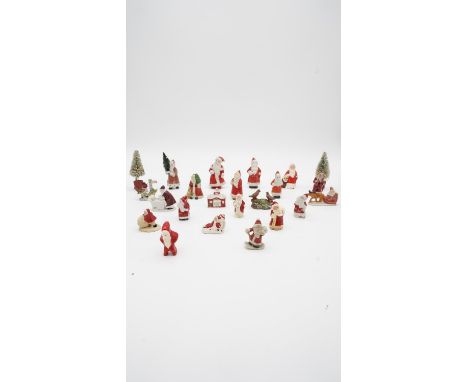 Twenty one vintage hand painted bisque porcelain Christmas cake decorations and two Christmas trees. Including a robin at the
