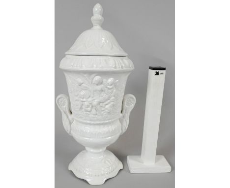 A Pereiras ceramic Portuguese white glazed Classical design two handled lidded urn. Makers stamp to the base. H.48 W.23cm 