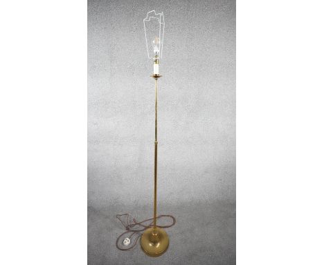 A vintage solid brass candle design height adjustable standard lamp with ridged circular base. H.167 