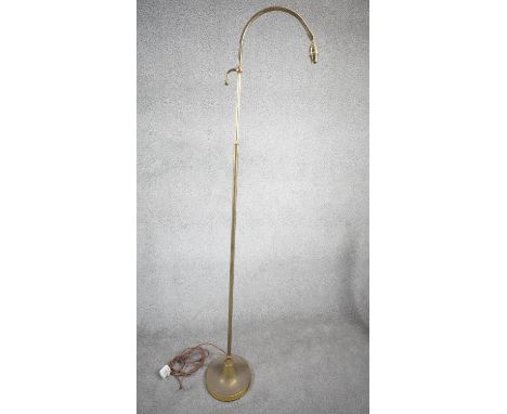 A vintage solid brass height adjustable arched design standard lamp with weighted circular base and silk wrapped cord. H.167 