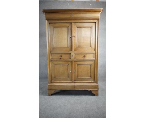 A late 19th century French Provincial oak pantry cabinet with frieze drawer above panel doors and drawers and a further pair 