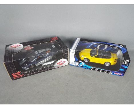 Guilloy, Maisto - Two boxed 1:18 scale diecast model cars. Lot includes Guilloy #67513 Prototype LM; with a Maisto Porsche 91