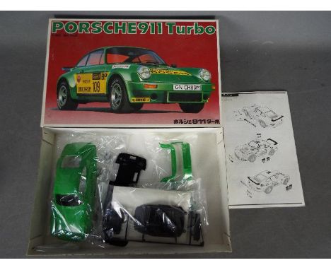 Bandai - A boxed vintage Bandai 1:20 scale Porsche 911 Turbo plastic model kit. The kit appears in Mint condition and contain