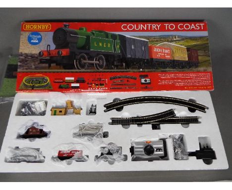 Hornby - A boxed Hornby R1201 'Country to Coast' OO gauge electric train set. Set includes a 0-4-0 tank engine in LNER livery
