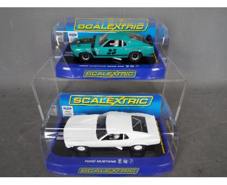Scalextric - 2 x Ford Mustang models, a 1969 in plain white finish and Boss 302 in Libra International Racing livery # C2450,