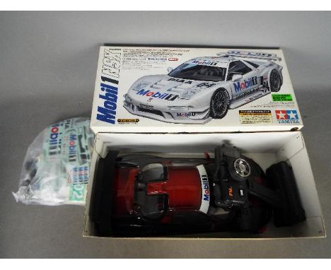 Tamiya - A boxed 1:10 scale TA03R Mobil 1 NSX radio controlled 4WD racing car. The model appears assembled with the body shel