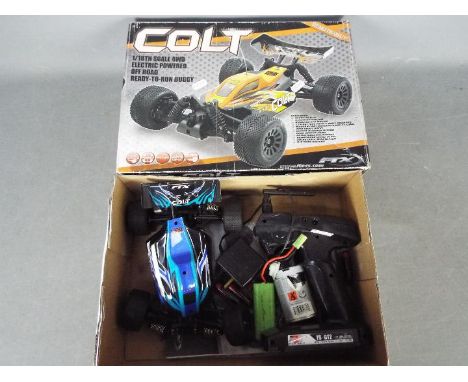 FTX - An assembled and boxed FTX Colt 4WD 1:18 scale Off Road Ready to Run Buggy. The model shows signs of use, generally app