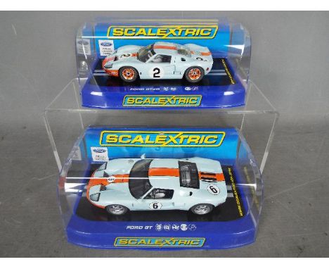 Scalextric - 2 x cars, Ford GT and Ford GT40 in Gulf colours. # C3324, # C3325. Both models appear Mint in Very Good display 