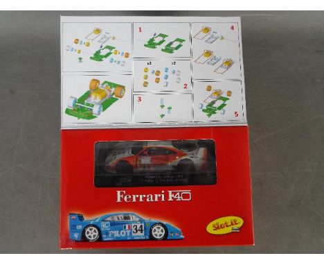 Slot-it - A Ferrari F40 self assembly model kit # KF02D. The model appears Mint and the parts are still sealed in bags. The b