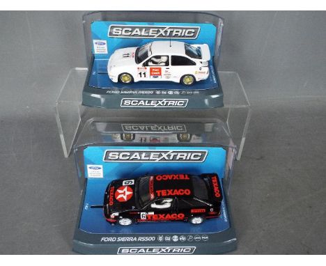 Scalextric - 2 x Ford Sierra RS500 Cosworth models, a 1990 BTCC version driven by Rob Gravett and a Texaco liveried car drive