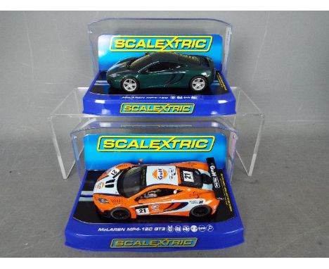Scalextric - 2 x McLaren MP4-12C models, a dark green metallic road car and a racing version in Gulf livery. # C3273, # C3287