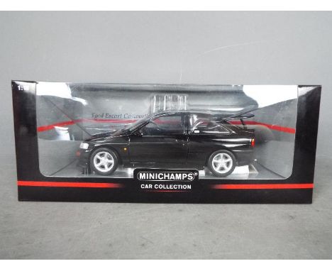 Minichamps - A boxed 1:18 scale diecast Ford Escort Cosworth 1992 by Minichamps. The model in black appears to be in Mint con