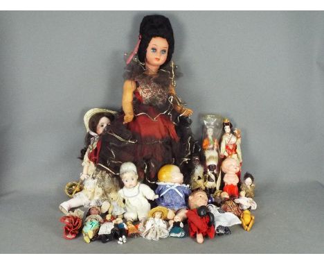A collection of unboxed vintage and modern dolls made from a variety of materials. Lot includes a large plastic Spanish doll 