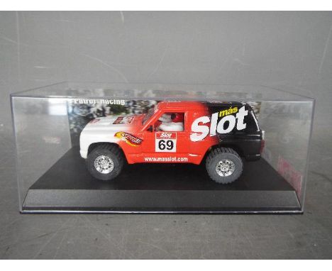 Scalextric - SCX - A limited edition Nissan Patrol TT model made for MAS Slot magazine. This 4 wheel drive slot car is one of