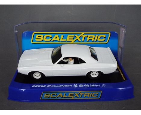 Scalextric - A Dodge Challenger in rare plain white livery # C3444 The car appears Mint in a Very Good display case with ligh