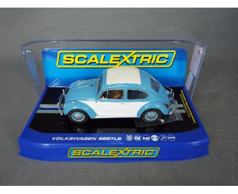 Scalextric - A rare 1963 Volkswagen Beetle in blue and white with sunroof. # C3204. The car appears Mint in a Very Good displ