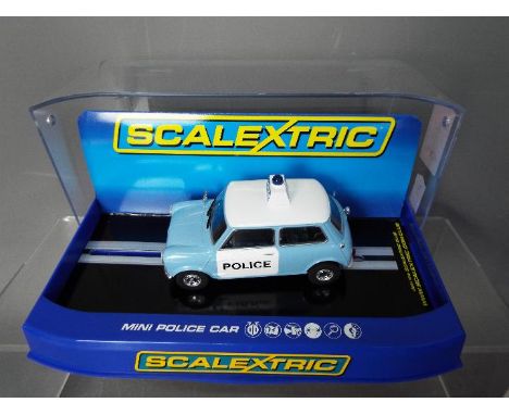 Scalextric - A Morris Mini Police Panda car in blue and white, # C3213. The car appears Mint in a Very Good display case with
