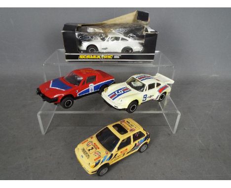 Scalextric - A group of four predominately unboxed Scalextric slot cars. Lot includes, C130 Triumph TR7; C125 Porsche Turbo 9