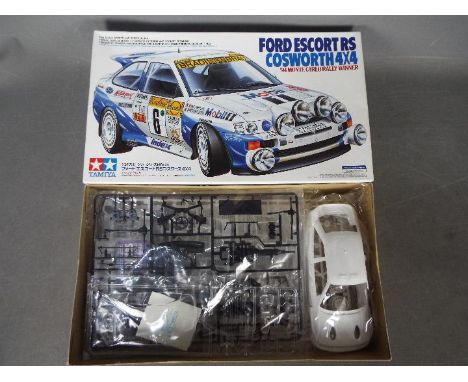 Tamiya - A boxed 1994 Tamiya #24144 1:24 scale Ford Escort RS Cosworth 4x4 '94 Monte Carlo Rally Winner plastic model kit. Th