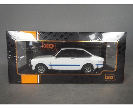 IXO - A boxed 1:18 scale diecast Ford #18CMC029 Ford Escort MK.II RS1800 1997 by IXO. Escort. The model in white appears to b