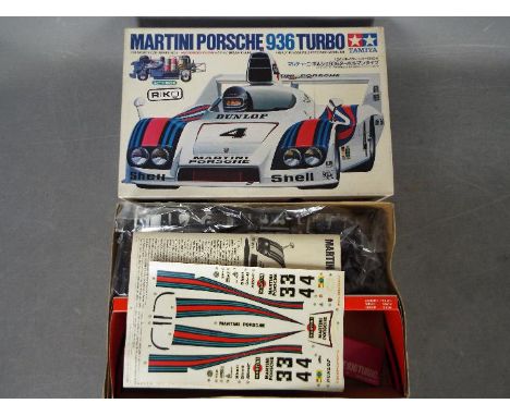 Tamiya - A boxed vintage Tamiya SS2404 1:24 scale Martini Porsche 936 Turbo plastic model kit. The kit contains loose parts a