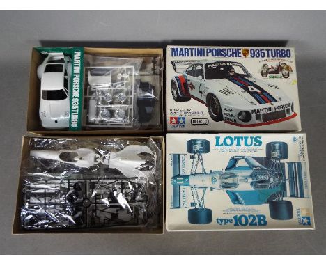 Tamiya - Two boxed plastic model car kits from Tamiya. Lot includes a Tamiya 1:20 scale #30 Lotus Type 102B; together with a 