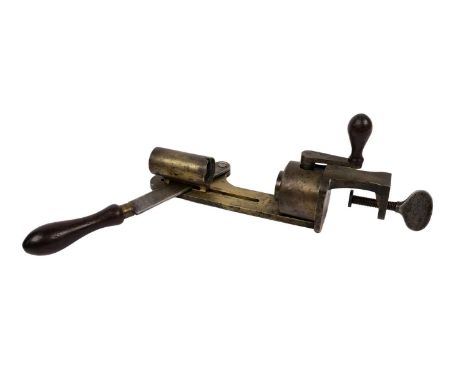 A Purdey Patent 12 bore cartridge turnover-tool, vertical brass plunger on a steel arm with turned wooden handle, brass base 