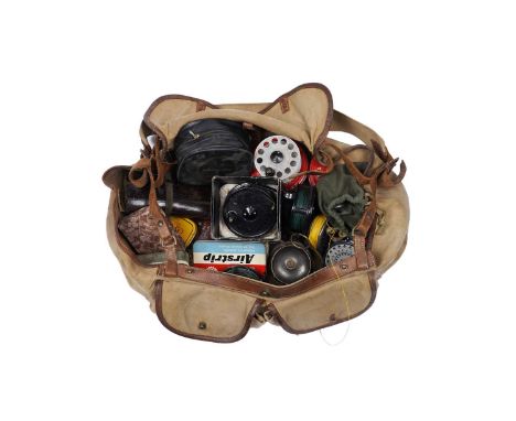 A Brady fishing tackle bag and contents, including: a Hardy leather fly wallet and flies; a selection of reels and spools; a 