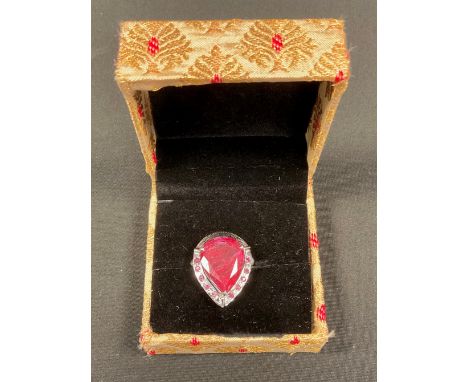 A Victorian style pear cut ruby ring, central pear cut ruby , ten smaller round cut ruby accents, total estimated ruby weight