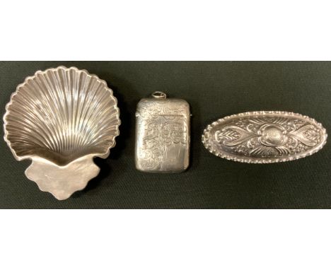An Edwardian silver trinket box, Chester 1902;  Victorian vesta case, Birmingham 1899;  George V shell bowl, Sheffield 1913, 