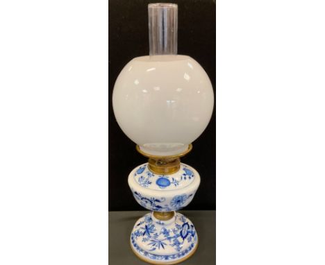 A Meissen design blue onion pattern oil lamp, Hinks patent wick adjuster;  frosted globular shade, 49cm high overall 