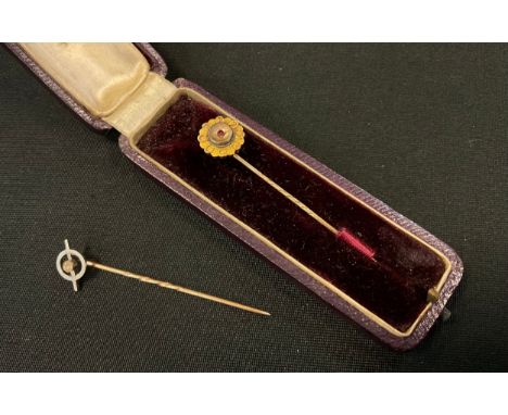 A 15ct gold ruby tie pin, floral top, stamped .625, spiral shaft, 1.2g gross;  another unmarked yellow metal 