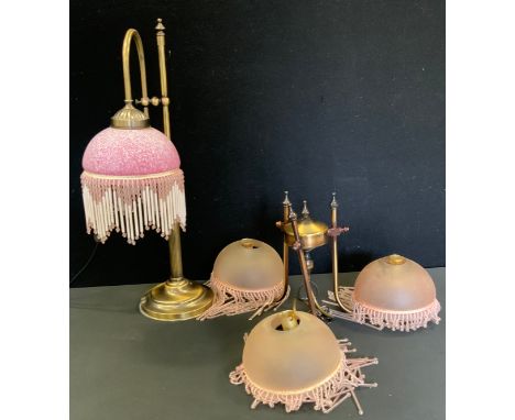 A bronzed metal table lamp, pink marble glass fringe shade, 54cm high;   similar three branch ceiling light, 46cm wide 