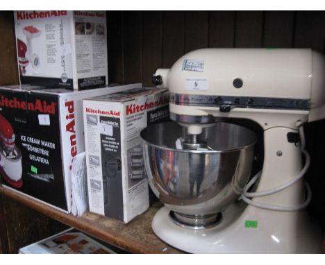 A KitchenAid KSM90 stand mixer with accessories and parts to include pasta roller set, icecream maker, food grinder, etc