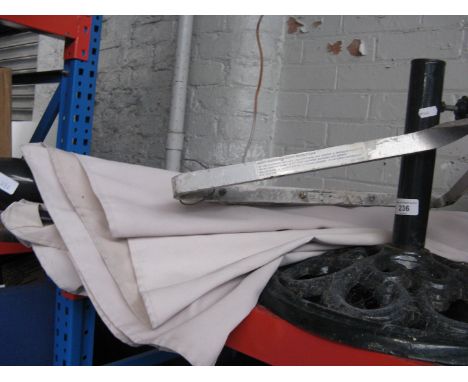 A parasol with metal stand and a ladder stand off 