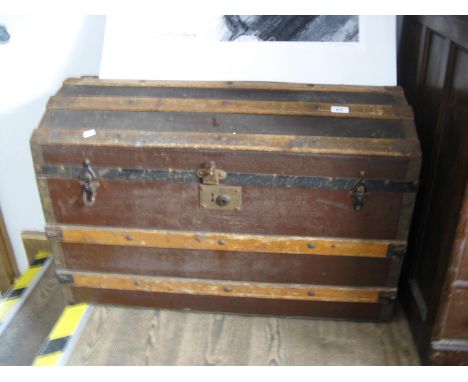 A domed top travel trunk and contents (linen) 