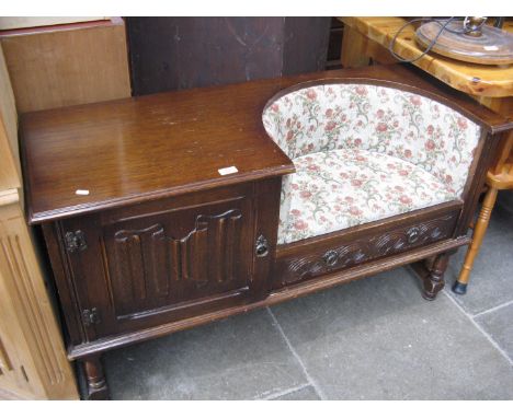 An oak telephone table with line  fold panel and tapestry upholstered seat 