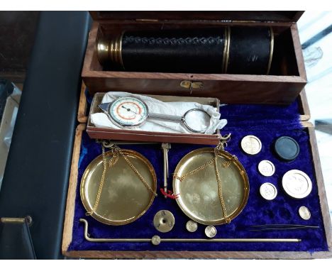 A mixed lot comprising a cased set of brass scales, a combined map measure and magnetic compass, a Thonrton slide rule and a 
