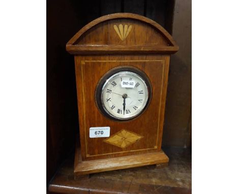 An inlaid mantle clock (quartz) 