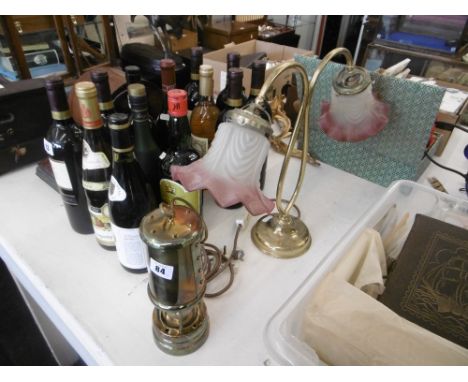 A brass miners lamp and a table lamp with glass shades