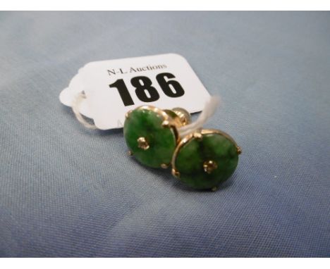 A pair of yellow metal jade and diamond stud earrings