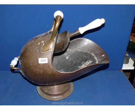 An old copper helmet shaped coal scuttle and shovel with ceramic handles.