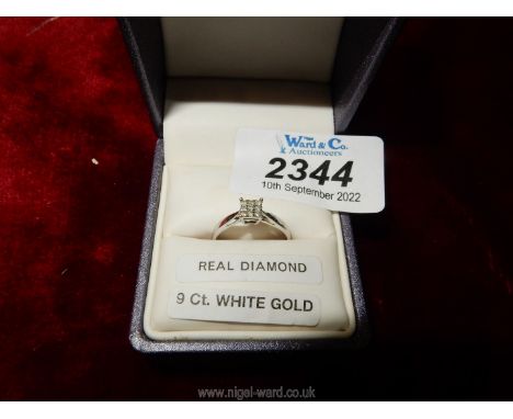 A 9ct white gold and diamond ring having nine small diamonds, in a modern square setting.