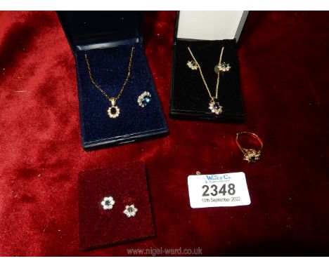 *An H. Samuel necklace with 9ct Gold Chain having flower shaped pendant, black centre stone with white stones surrounding, to