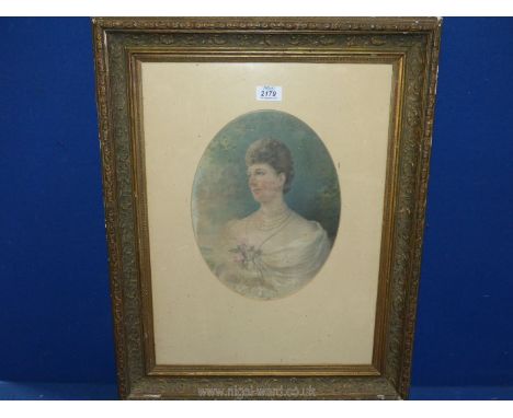 An ornately framed oval mounted print of a young lady holding flowers