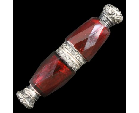 A Victorian silver-mounted facet-cut ruby glass double scent bottle, its respectively hinged and screw-on caps relief decorat