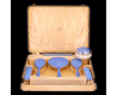 A 1930s enamelled silver seven-piece dressing table set, each bearing rose engine-turned and blue basse taille enamelled deco