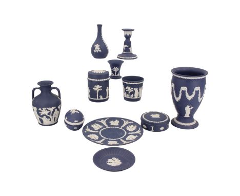 A group of Wedgwood dark blue Jasperware, including a Portland vase, various lidded boxes and a candlestick, tallest 20 cm