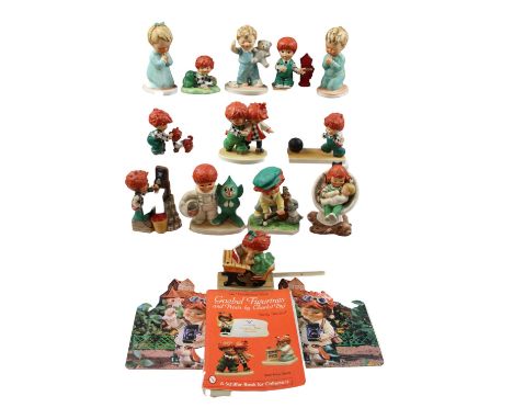 A group of Goebel Hummel figurines, together with two 1980 figurine calendars and Charlot Byj, "An unauthorized guide, Goebel