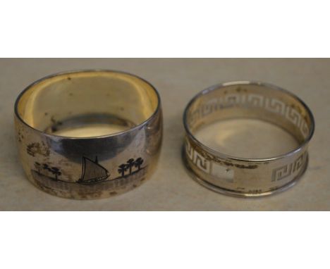 Foreign silver napkin ring decorated with niello shipping scenes and one other decorated with the greek key pattern (one smal